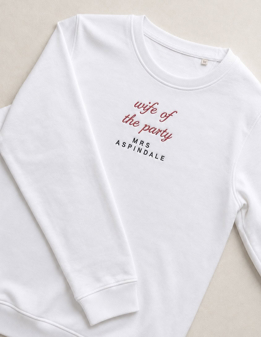 Embroidered sweatshirt with "Wife of the Party" and "Mrs. Aspindale" text, perfect for bridal or wed.