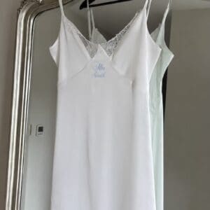 Elegant white satin slip with lace details for bridal wear.