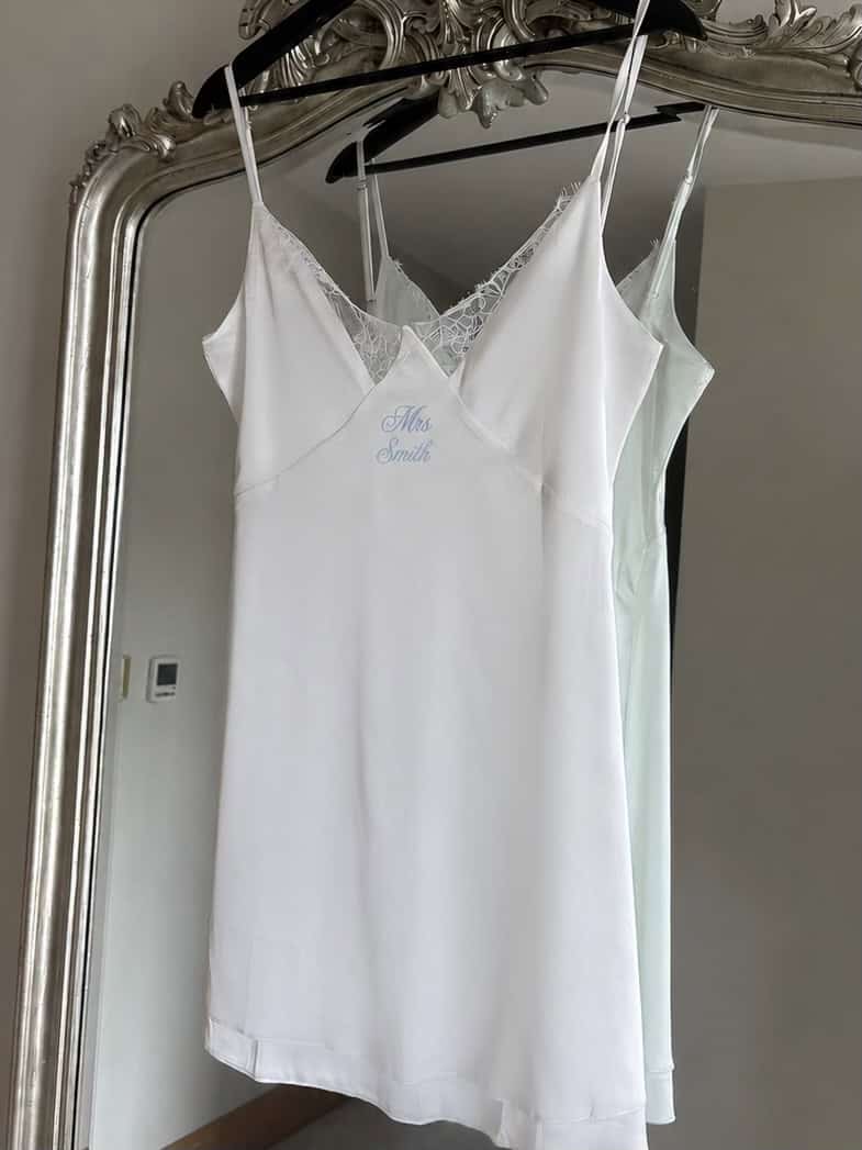 Elegant white satin slip with lace details for bridal wear.