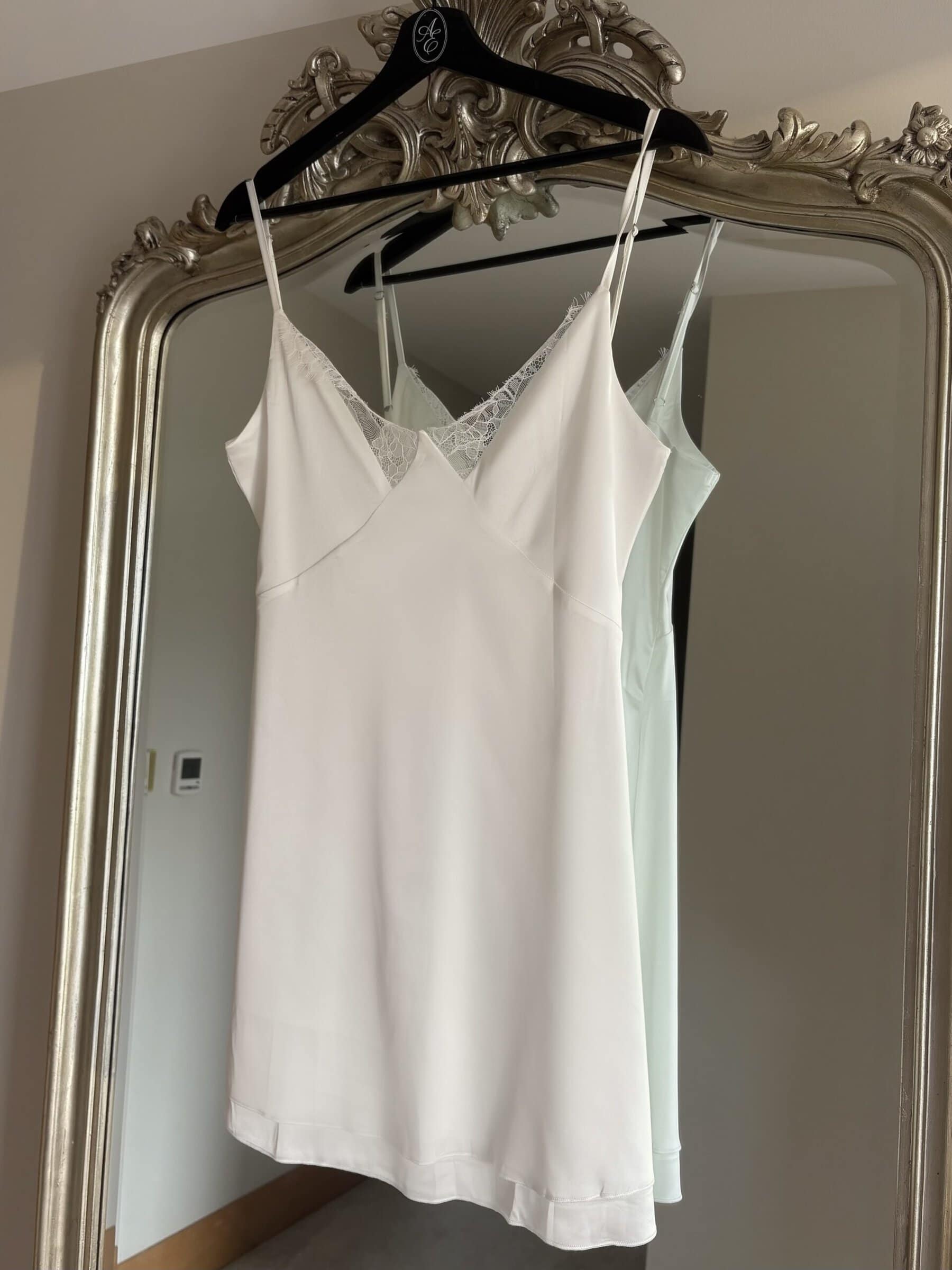 White satin bridal slip with lace details on thin straps.